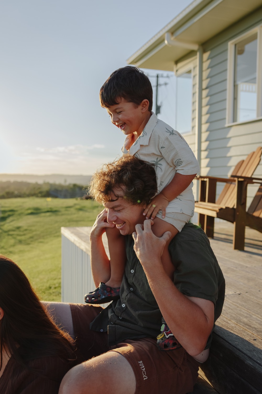 Elliot, CoasTrade's fencer, with his son on his shoulders at golden hour